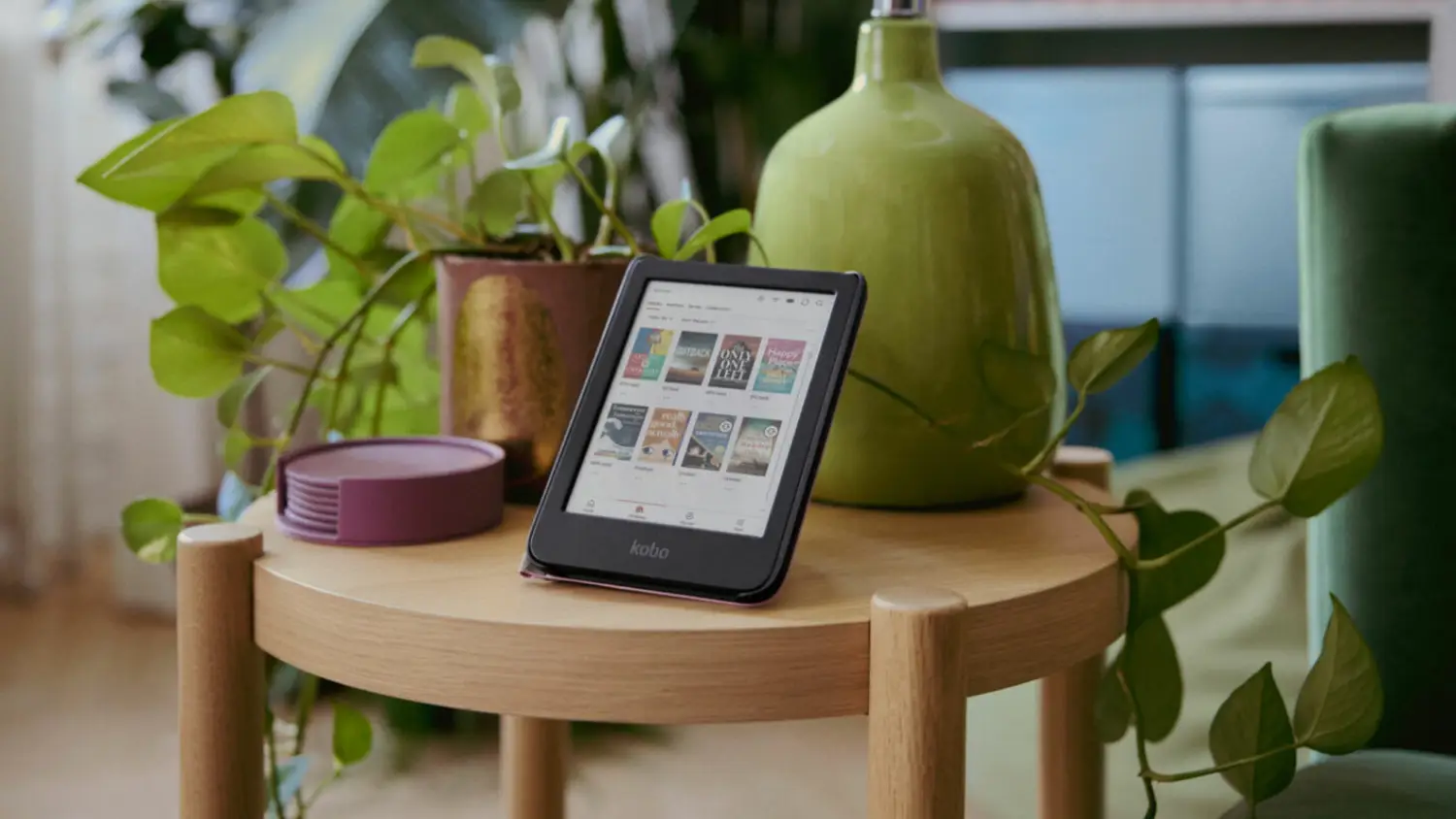 The Kobo Clara Colour on a coffee table with a plant