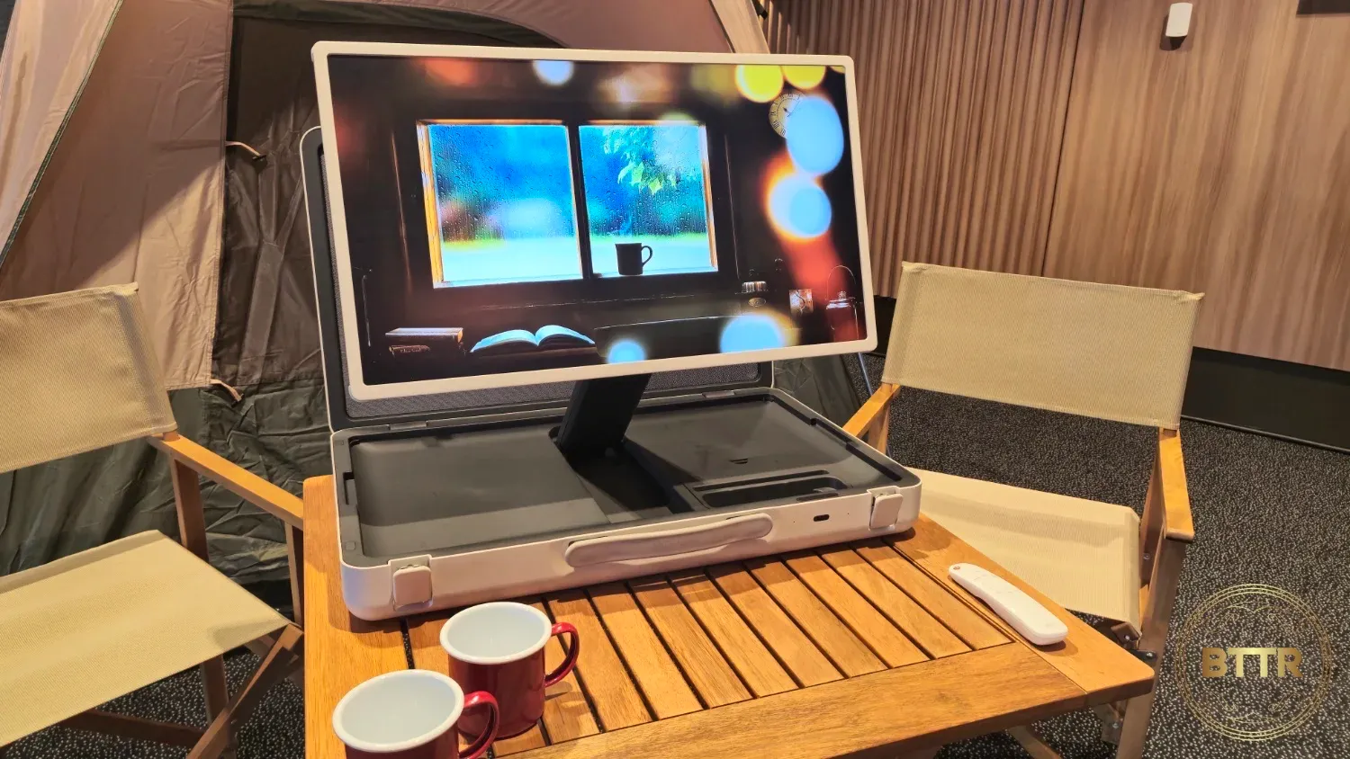 LG StanbyME GO TV in a suitcase on a camping table