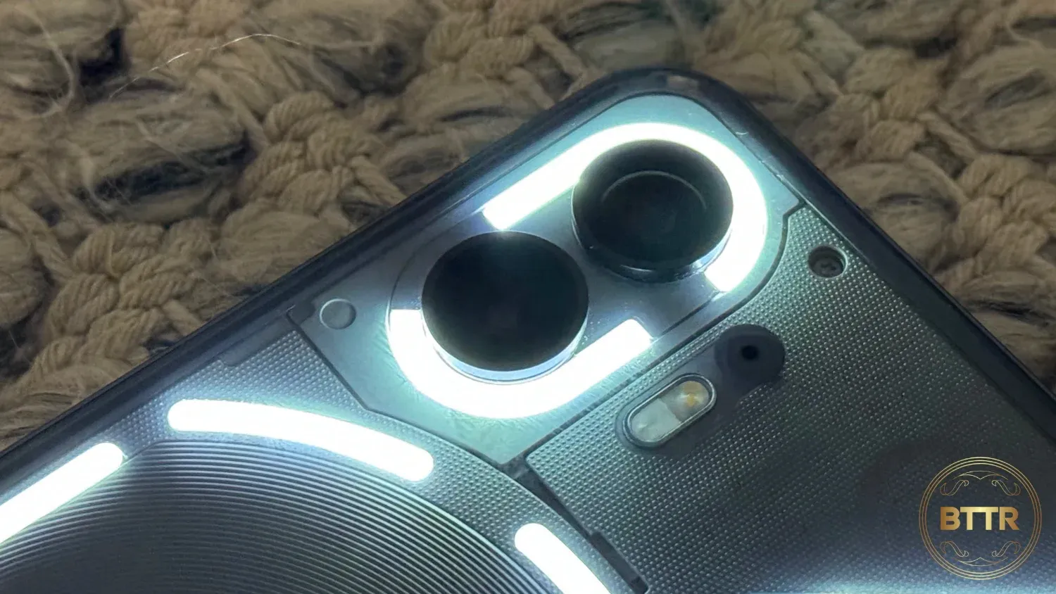 Close up of the glyphs lighting up on the Nothing Phone (2)