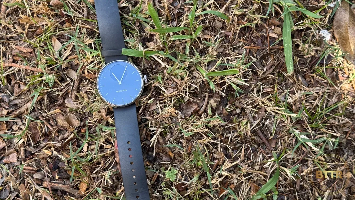 The ScanWatch Light in Black and silver on some grass