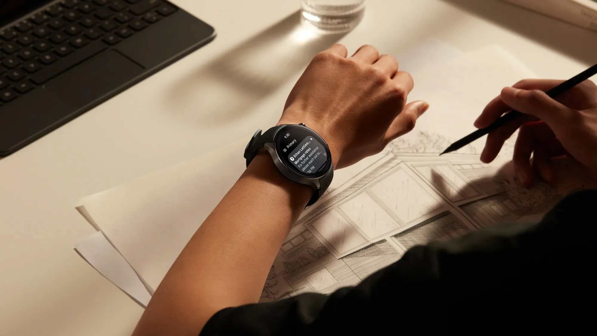 The OPPO Watch X on a wrist of a man drawing a building