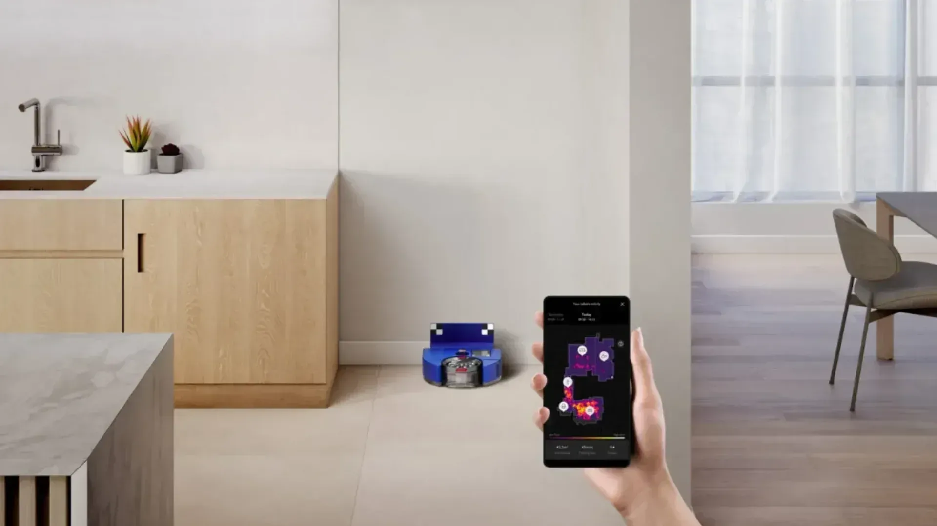 The Dyson 360 Vis Nav charging with someone holding a phone in front of it