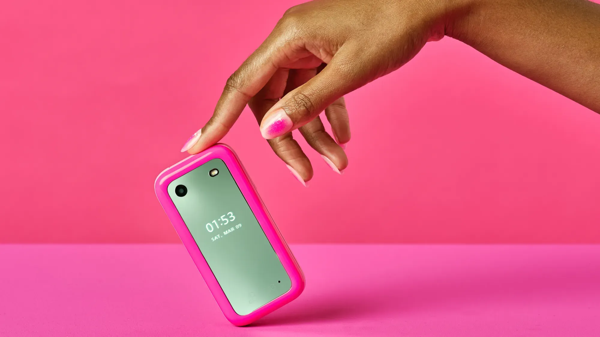 A finger holding the Barbie phone up