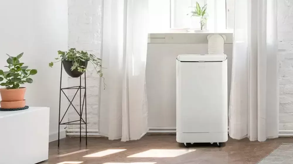 Kogan portable air conditioner in a room next to a window