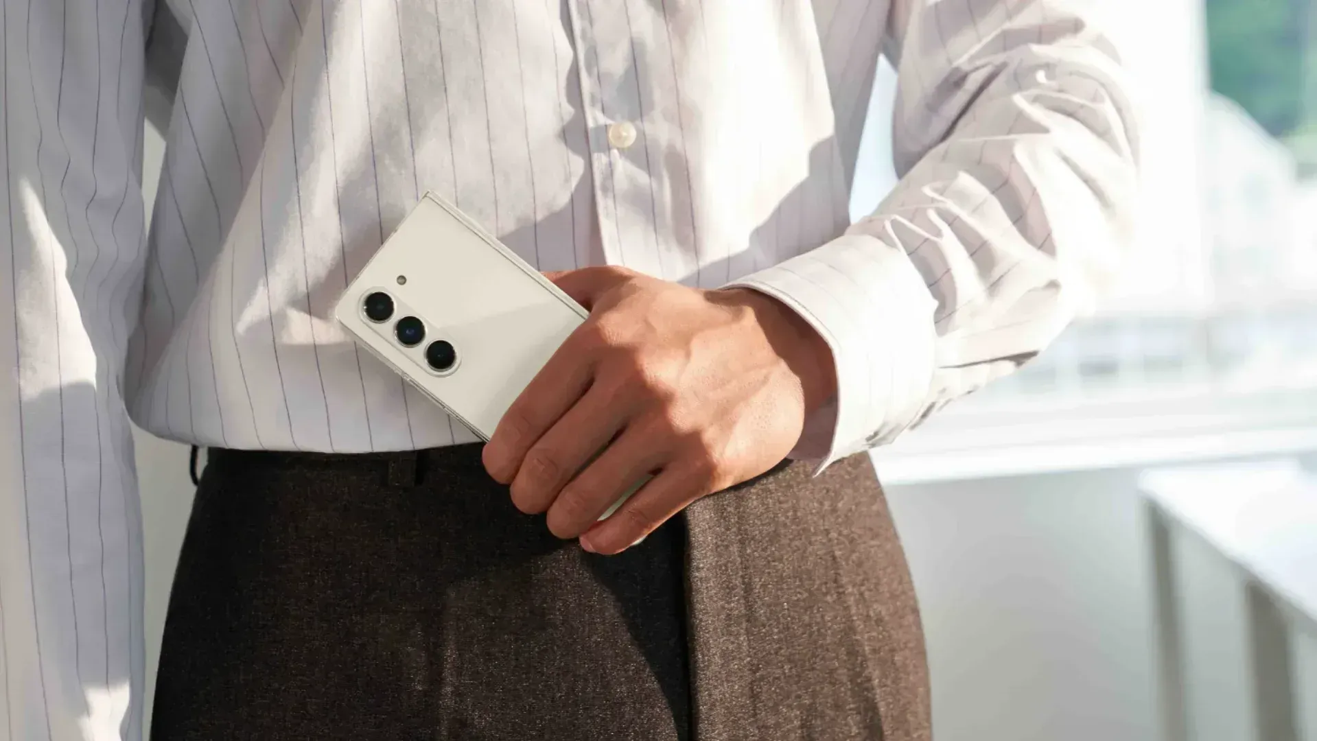 A man holding the folded Galaxy Z Fold 5 from Unpacked