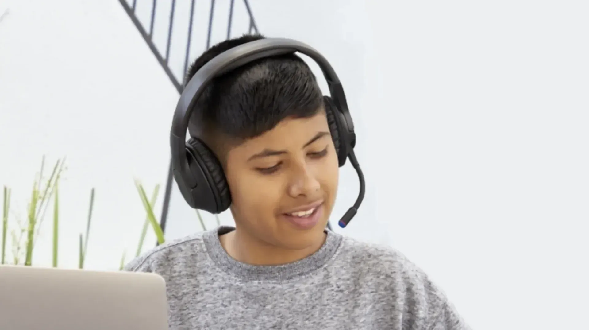 A young boy wearing the black soundform inspire headset