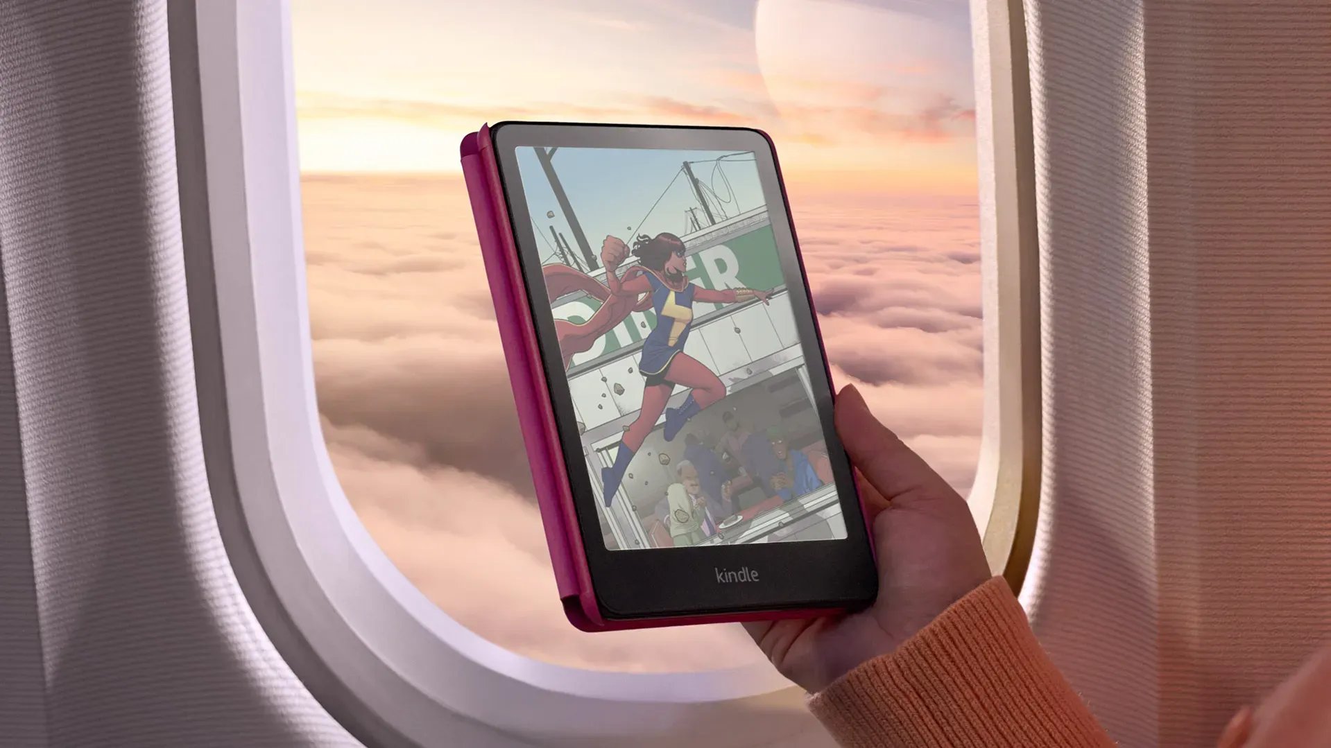 The Kindle Colorsoft showing a Ms Marvel Comic in front of a plane window