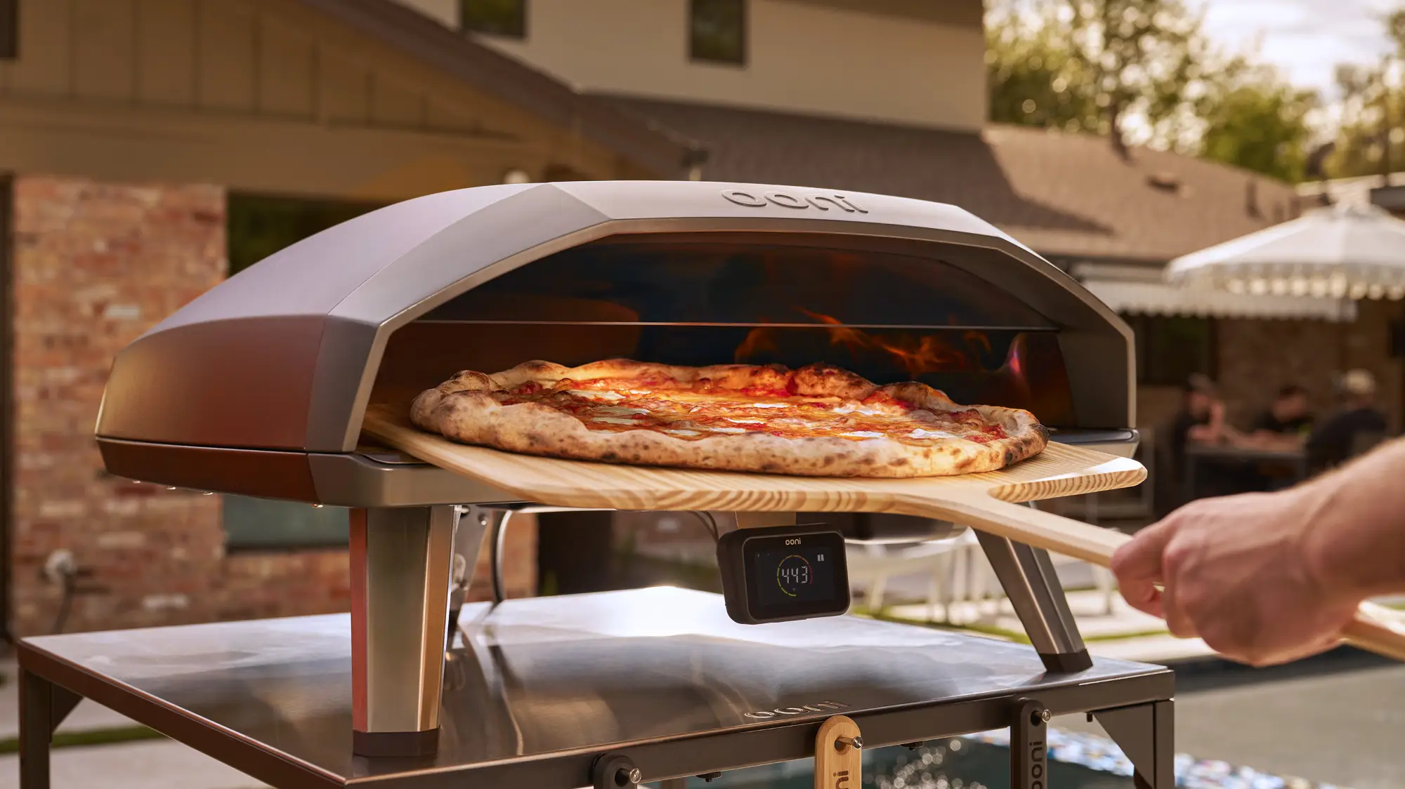 A pizza going into the Ooni Koda 2 Max gas pizza oven