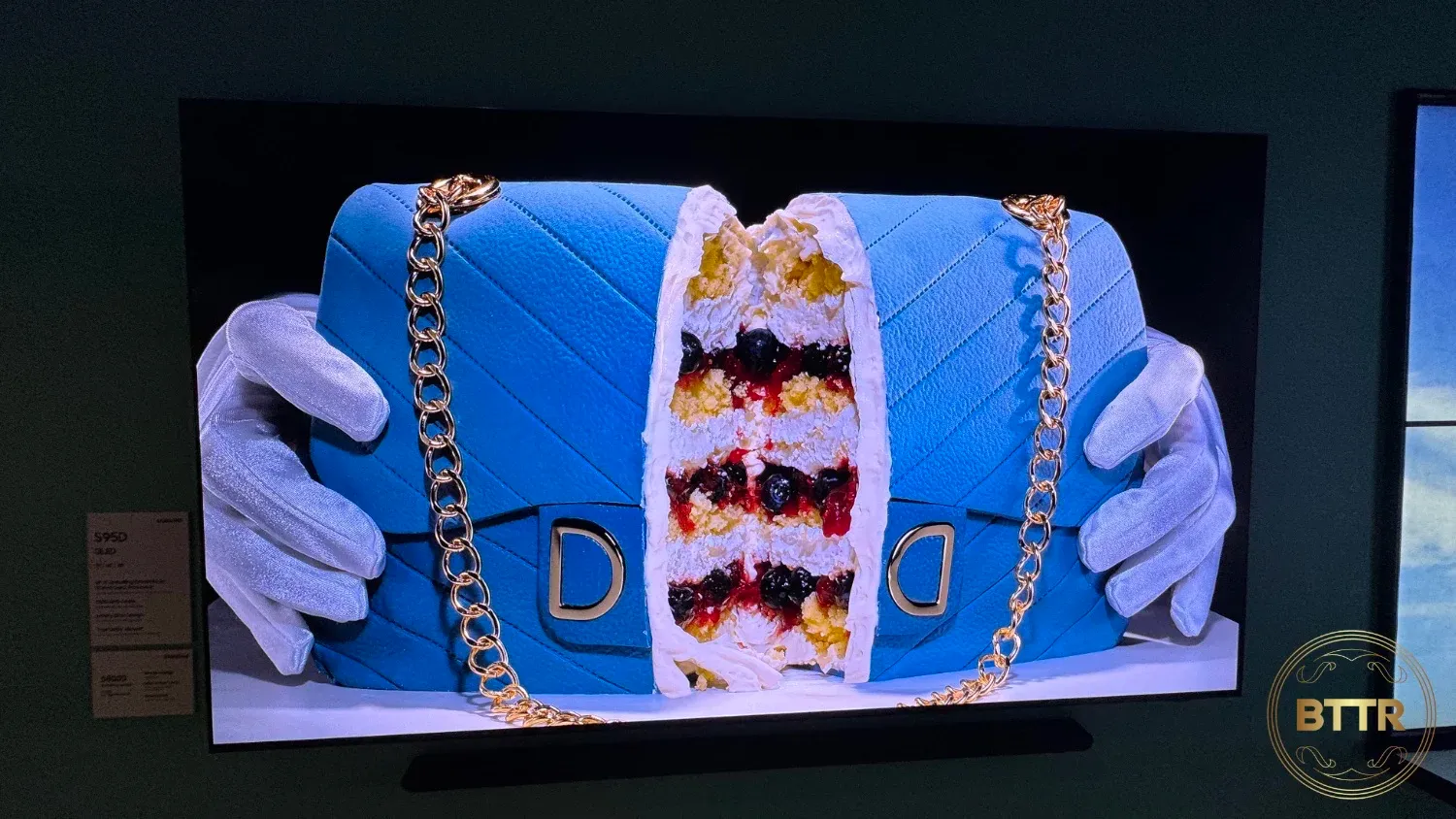 A Samsung TV displaying a cake that looks like a handbag being opened in half.