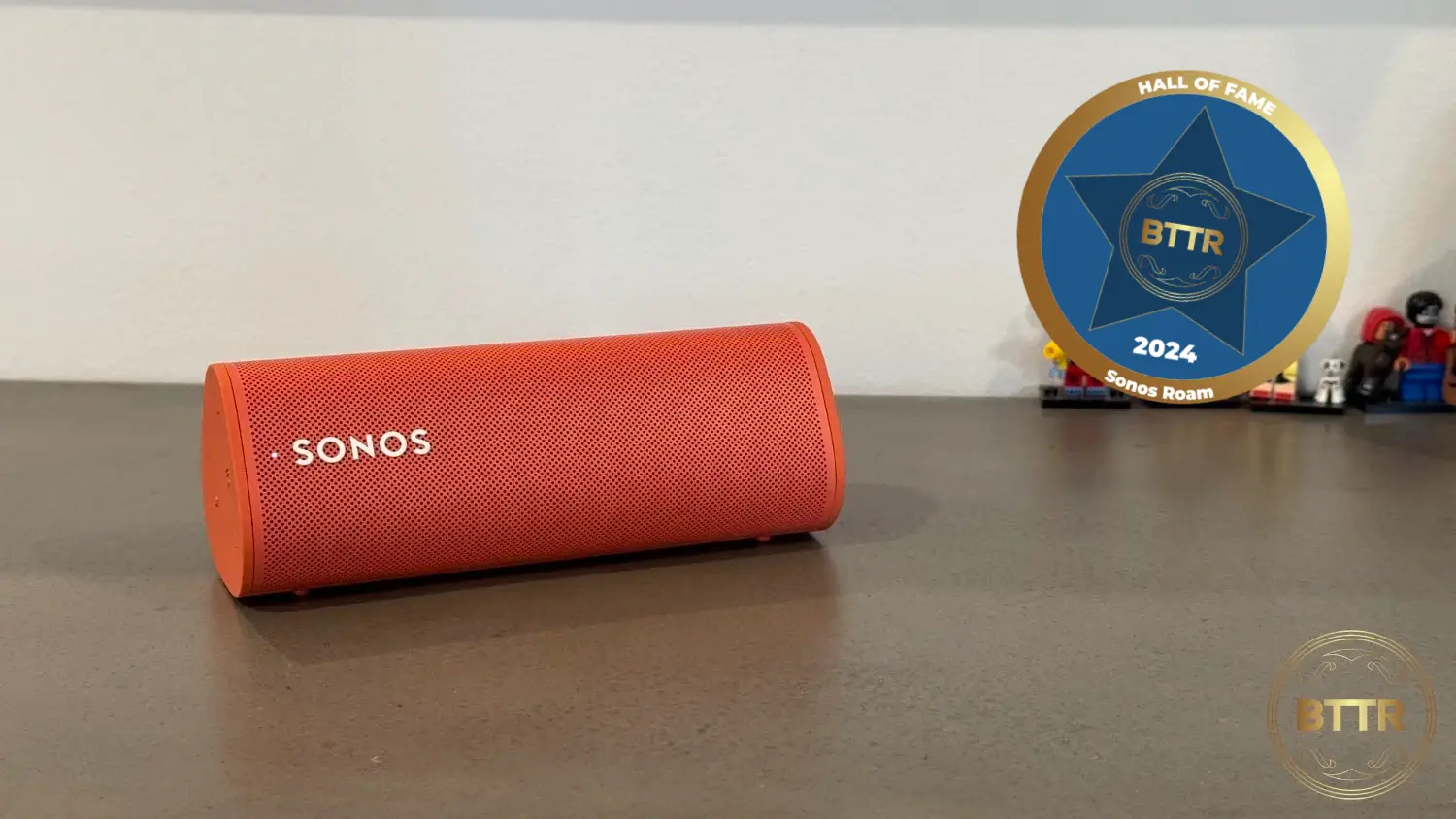 Sonos Roam in Orange with a BTTR Hall of Fame badge overlay