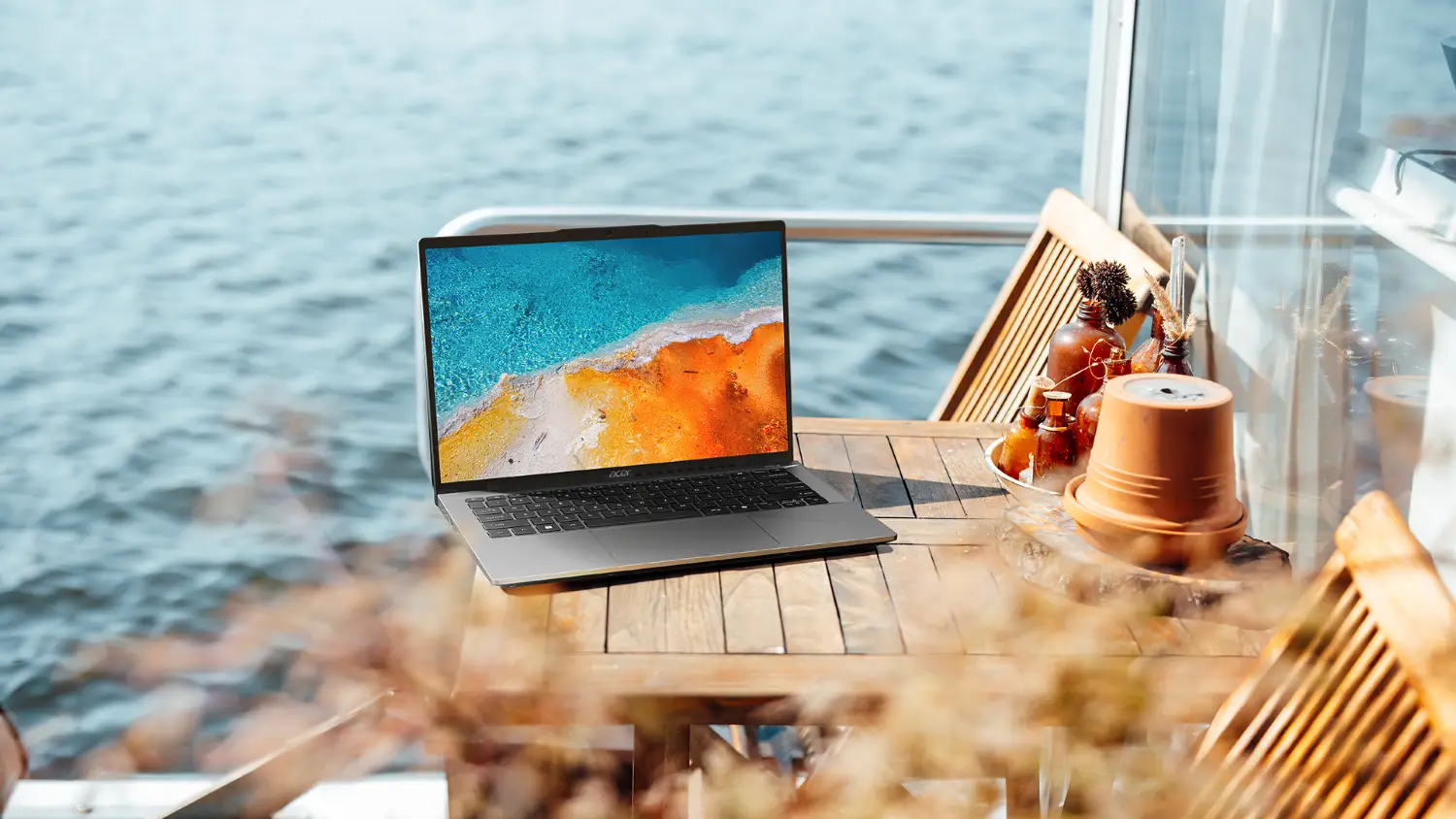 Acer Swift Go 14 laptop on a table in front of the ocean