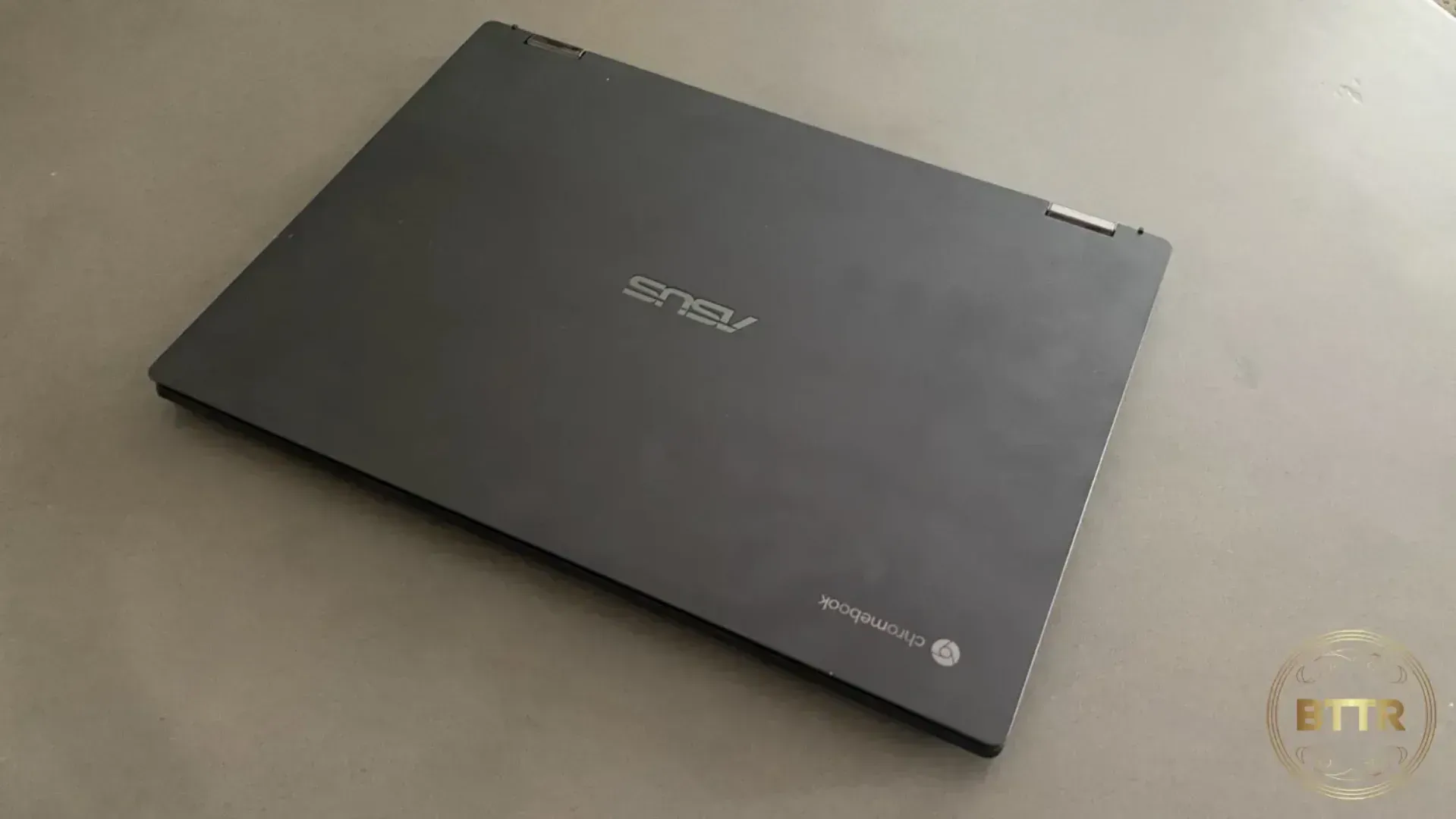 The Asus Chromebook CX5 Flip, closed on a concrete coffee table