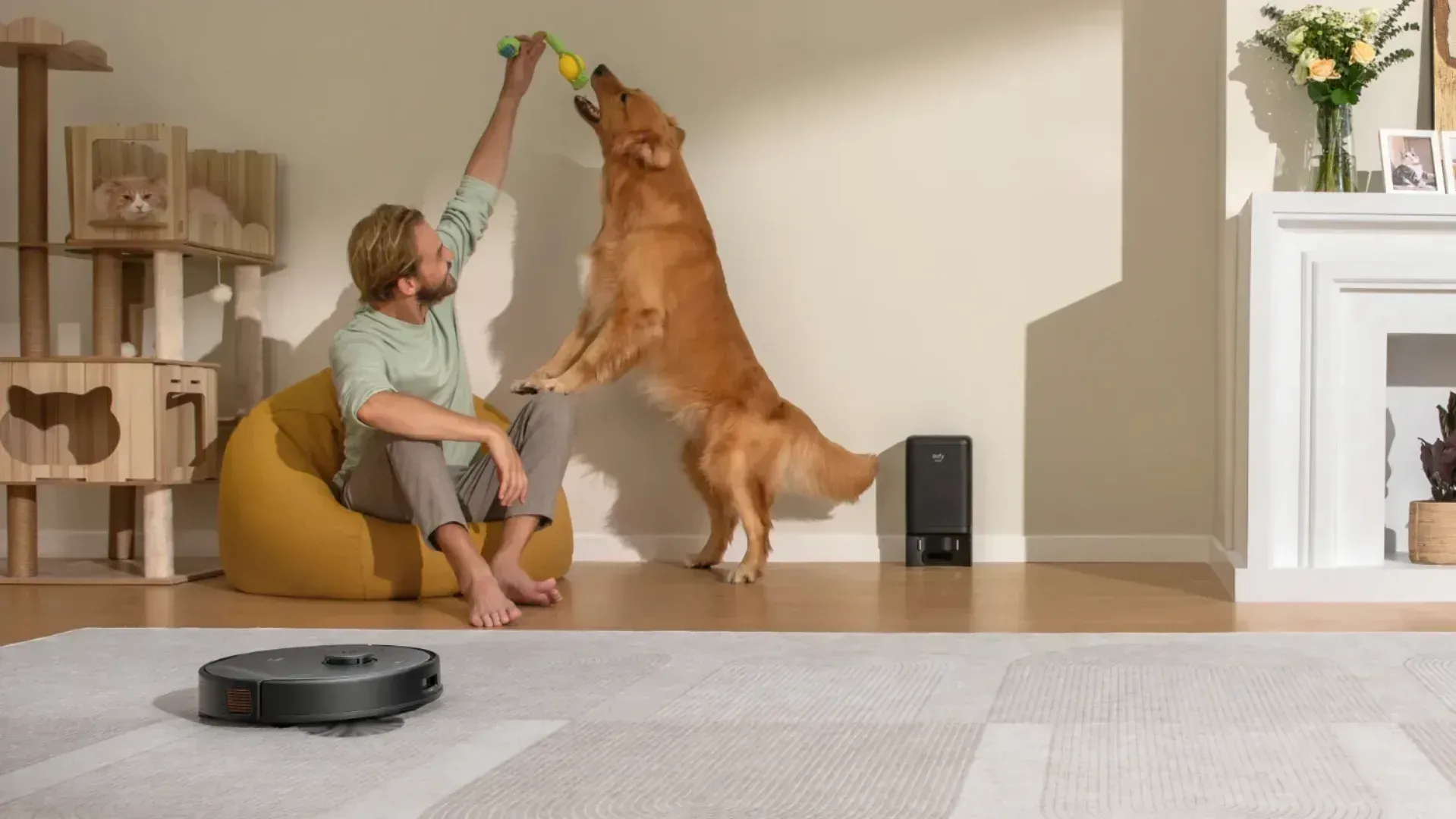 Man playing with dog while eufy robot vacuum cleans