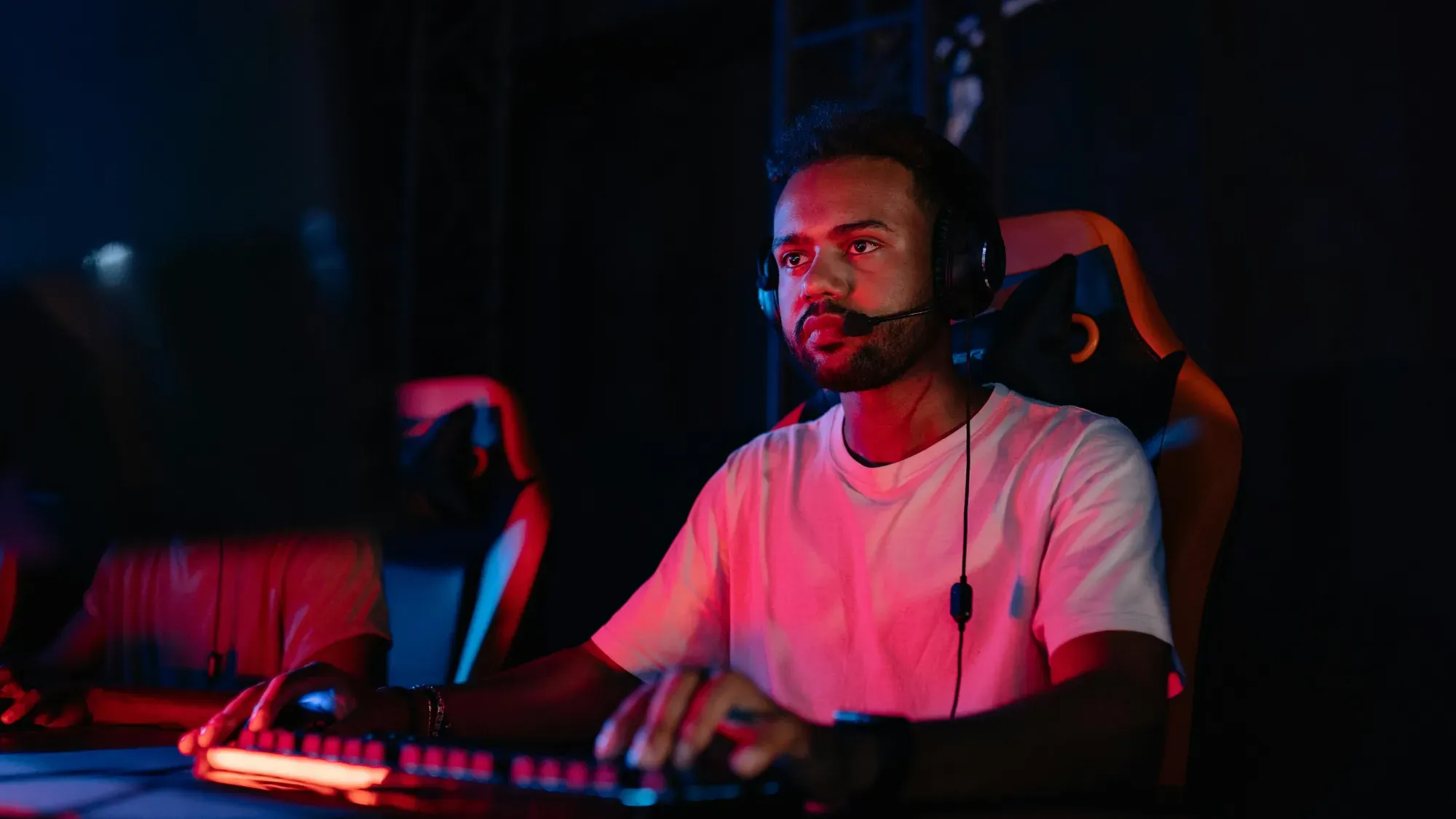 A man playing games while wearing a gaming headset