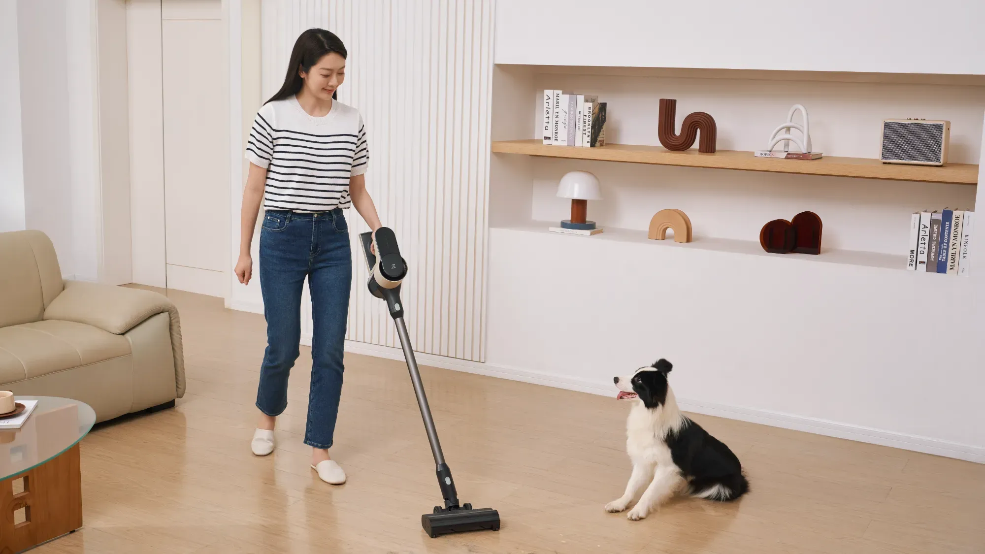 Roborock H5 being used while a dog looks on