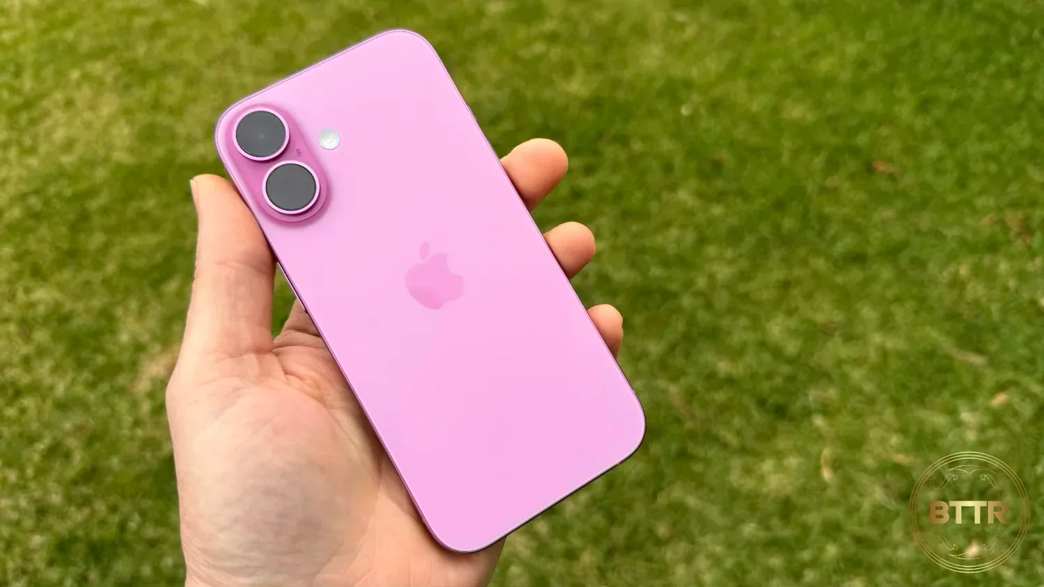 Holding the pink iPhone 16