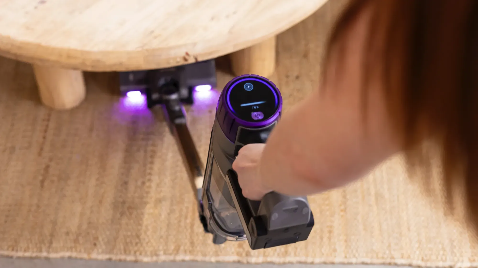 The Shark PowerDetect Clean & Empty cleaning under a coffee table