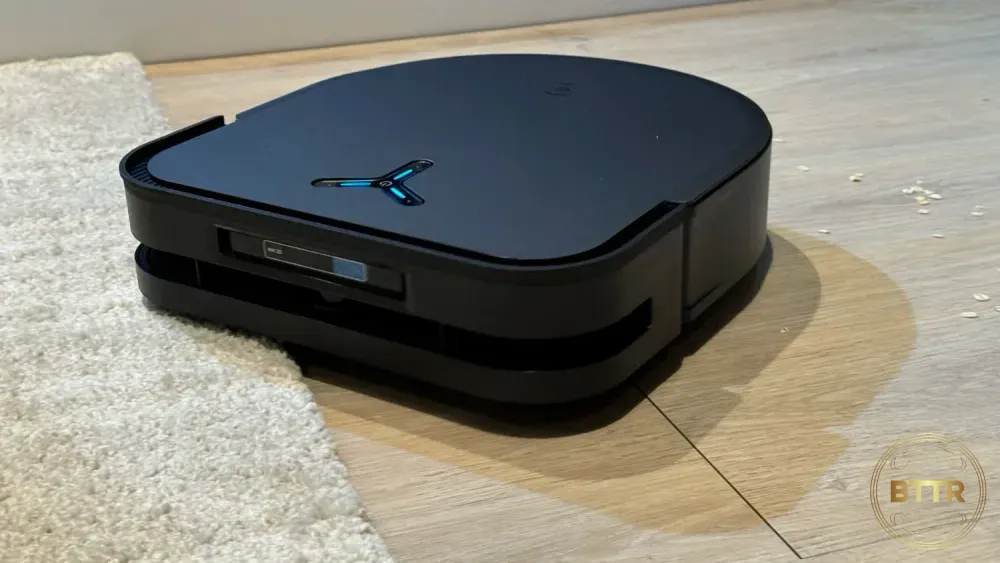 The Ecovacs Deebot X5 Pro Omni cleaning oats off the floor.