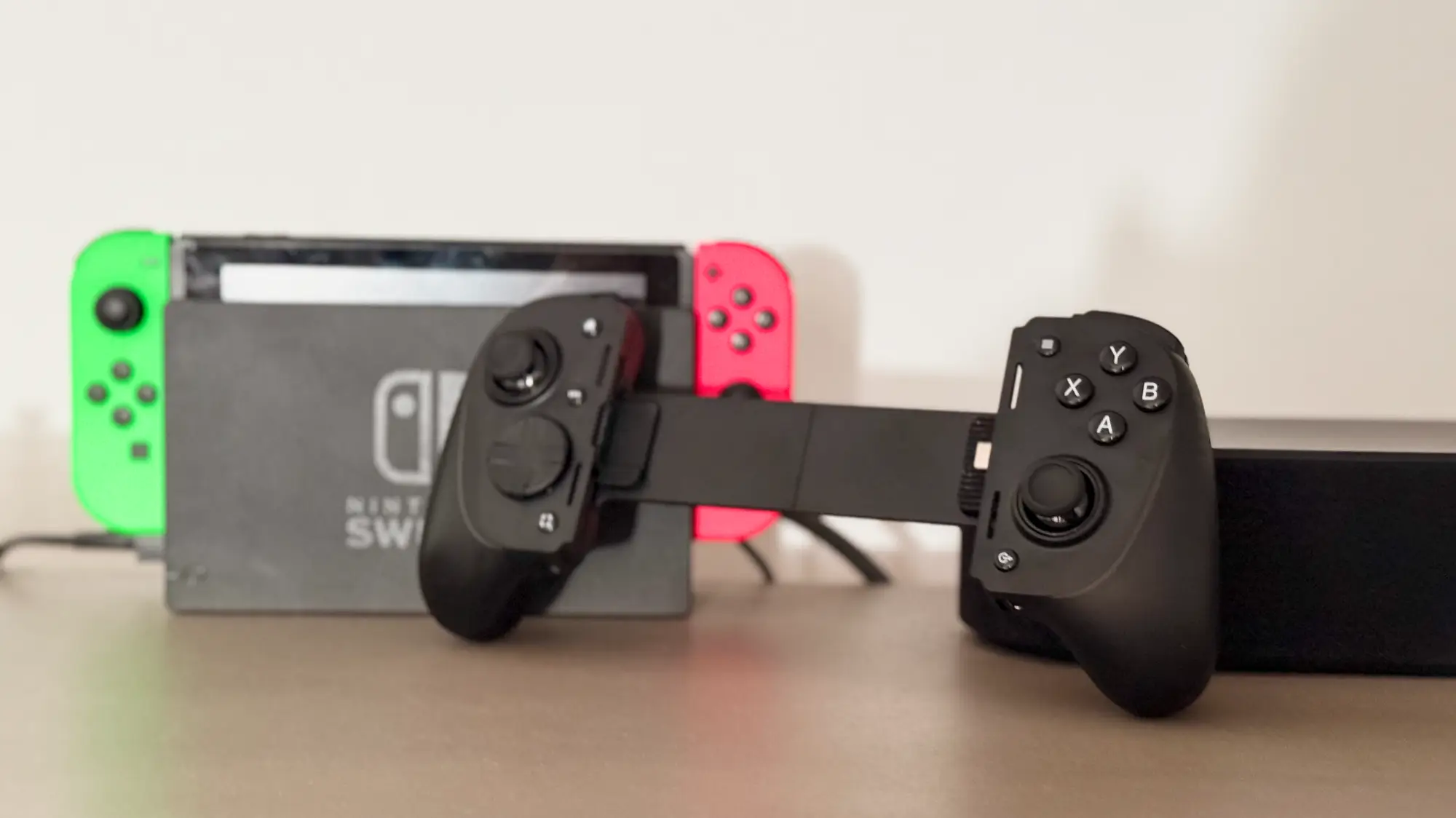 The Razer Kishi Ultra in front of a Nintendo Switch