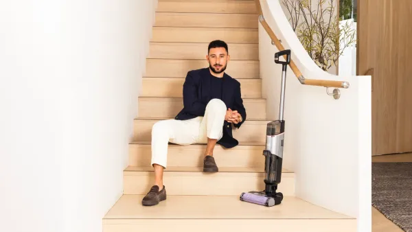 A man sitting on stairs with the Shark HydroVac