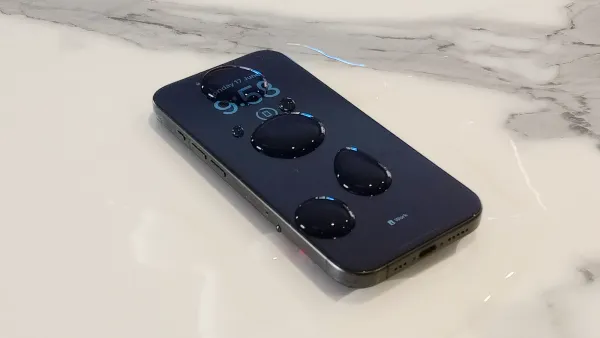 An iPhone with water on top and around it