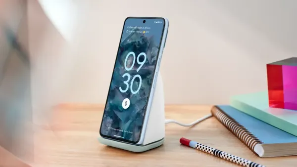 Pixel 8 Pro on a stand on a desk with books and a pencil