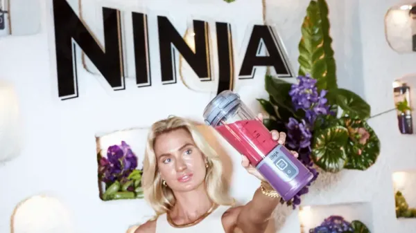 Woman holding the Ninja Blast blender