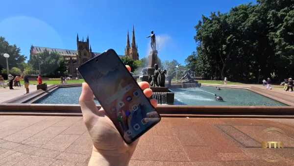 Oppo A79 5G in front of a fountain in hand