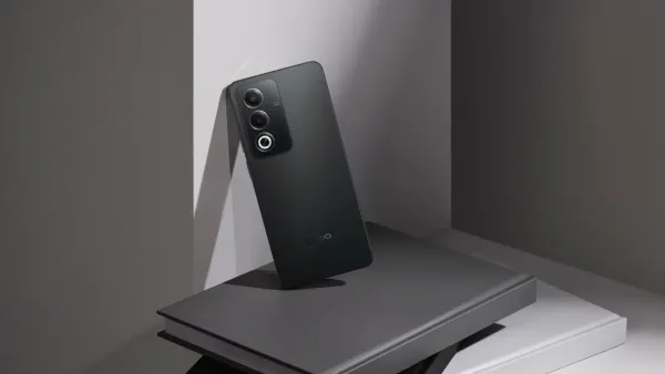 Oppo A80 in black on a stack of black and white books