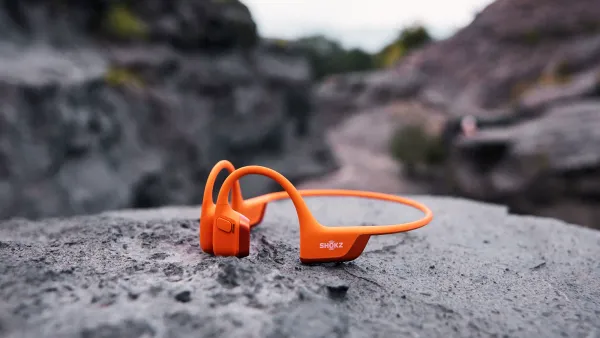 Orange Shokz Openrun Pro 2 on a rock