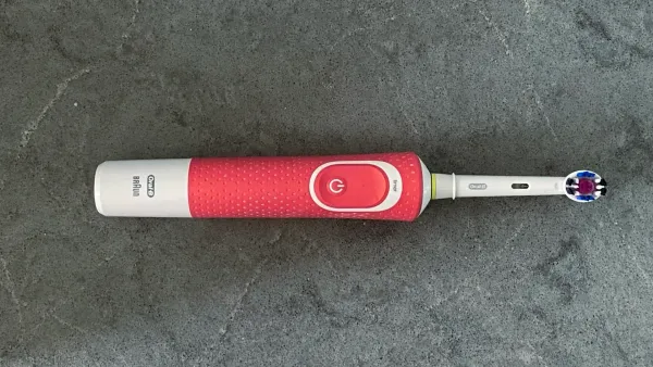 An electric toothbrush on a benchtop