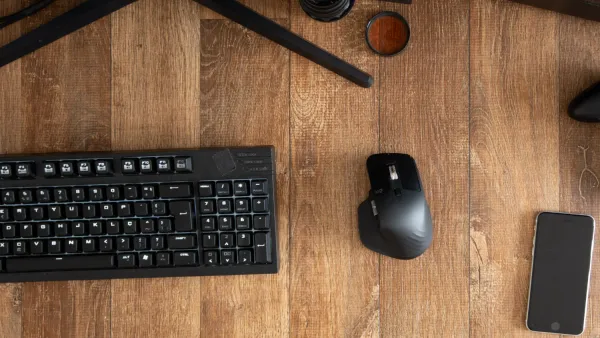 A desktop with a mouse and keyboard and phone