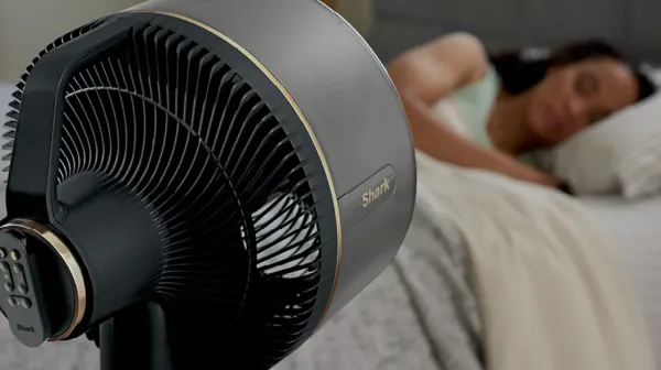 The Shark FlexBreeze fan blowing on a woman in bed