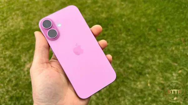 The pink iPhone 16 in hand