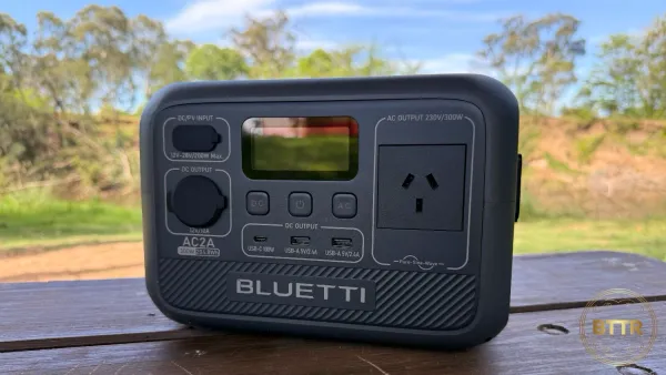 The Bluetti AC2A on a picnic table by a river