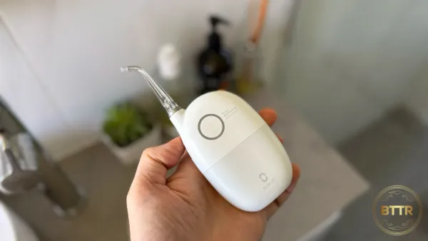 Holding the Oclean water flosser in my hand after unboxing