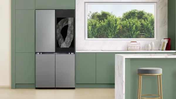 The Samsung Family Hub fridge in a greenish kitchen setting