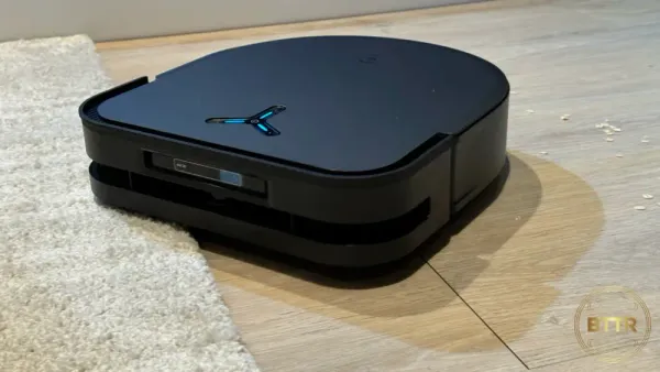 The Ecovacs Deebot X5 Pro Omni cleaning oats off the floor.