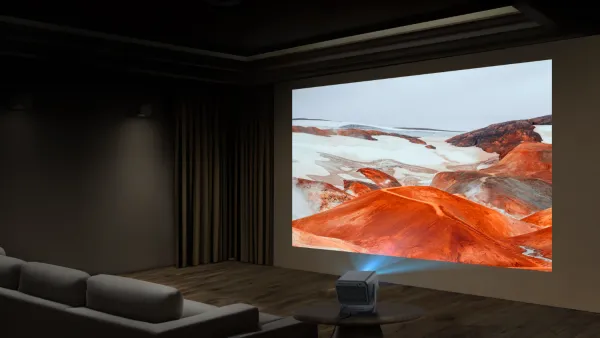 The new Hisense laser projector on a coffee table beaming out onto a wall