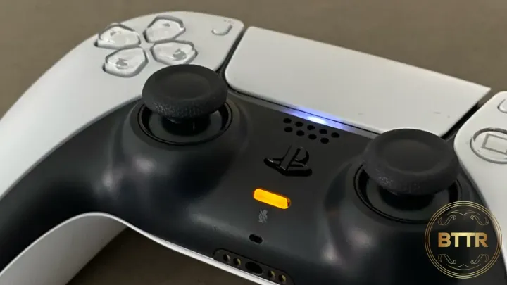 PS5 DualSense review - close up of the controller with the microphone light on