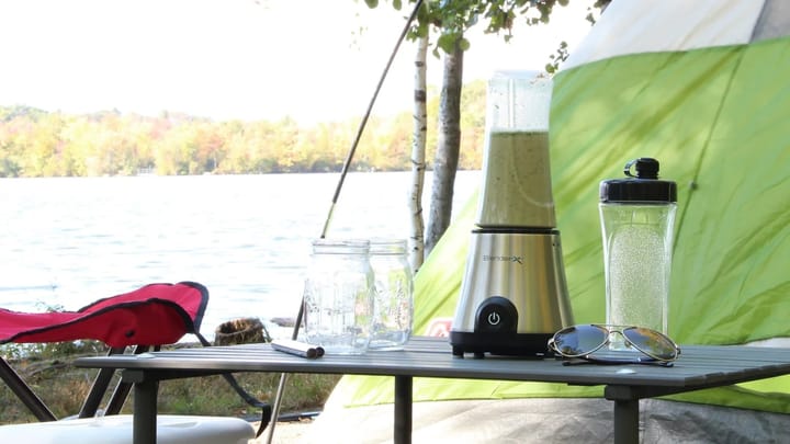 A portable blender on a camping table