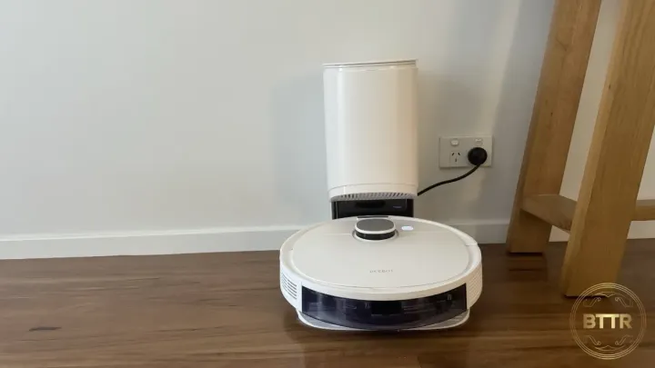 Ecovacs N10 Plus plugged into a wall on its base station